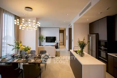 Luxurious open-plan living and dining area with modern kitchen and elegant decor.