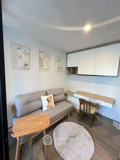 Cozy modern living room with stylish furniture and decor, featuring a comfortable sofa and wooden accents.