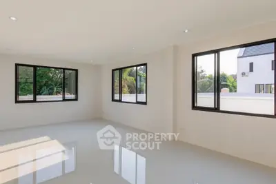 Spacious modern living room with large windows and natural light