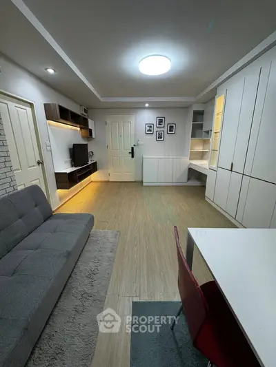 Modern living room with stylish furniture and built-in storage, perfect for urban living.