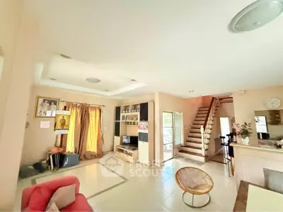 Spacious living room with modern decor and staircase in a bright home