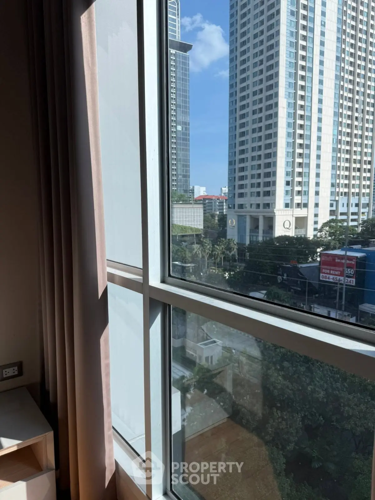 Stunning city view from a modern apartment window, showcasing urban living at its finest.