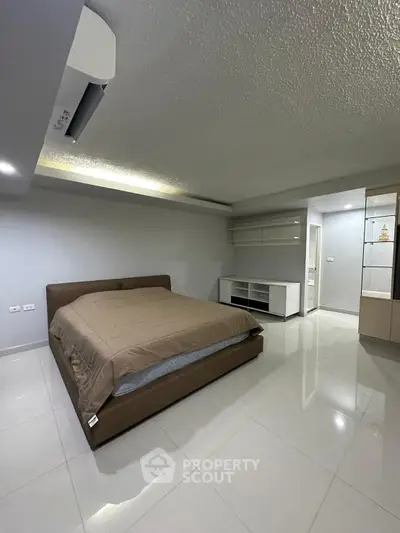 Spacious modern bedroom with sleek design and neutral tones