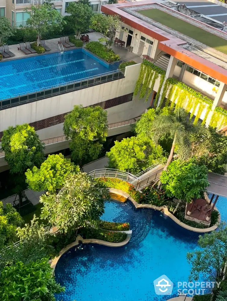 Luxurious residential complex with stunning rooftop pool and lush garden views.