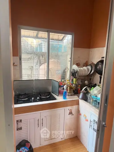 Cozy kitchen with gas stove and ample storage space, perfect for culinary enthusiasts.