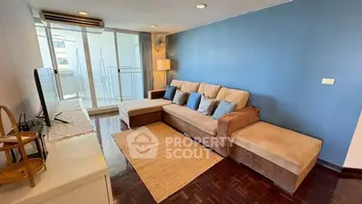 Spacious living room with modern decor and balcony access, perfect for relaxation and entertainment.