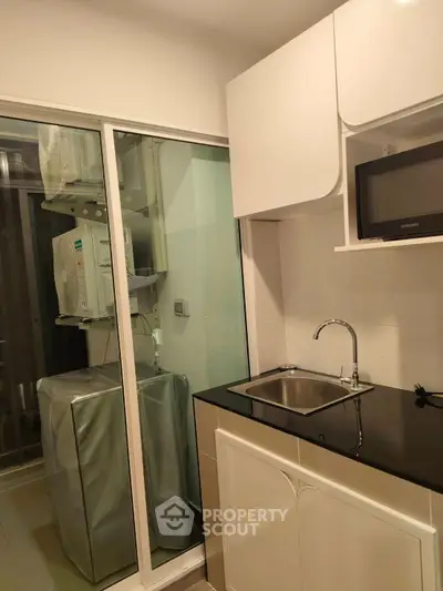 Modern kitchen with sleek cabinetry and compact design