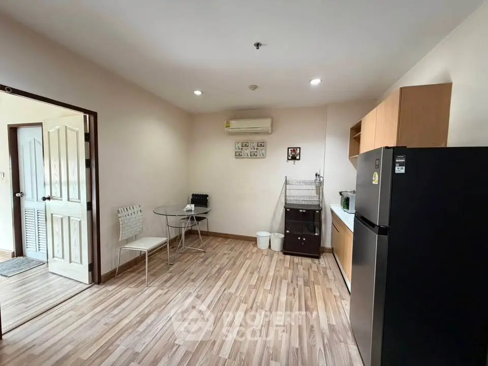 Cozy kitchen with modern appliances and dining area in a stylish apartment.