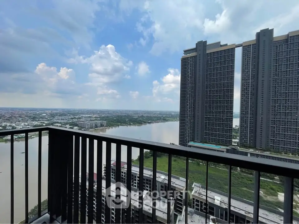 Stunning high-rise balcony view overlooking river and cityscape