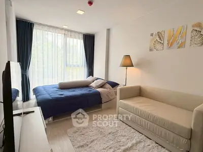 Modern bedroom with cozy decor and natural light in a stylish apartment.