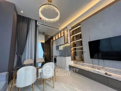 Luxurious modern living room with elegant chandelier and sleek TV setup