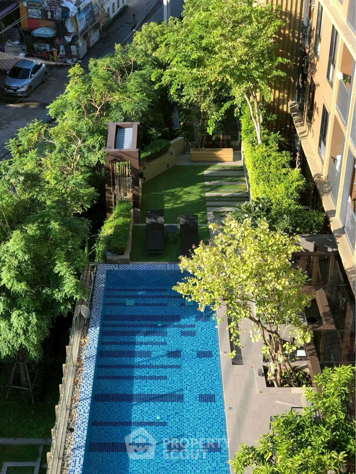 Luxurious rooftop pool with lush greenery and modern design, perfect for relaxation and leisure.