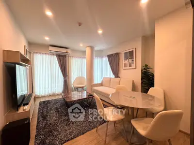 Modern living room with stylish furniture and natural light, perfect for relaxation and entertainment.