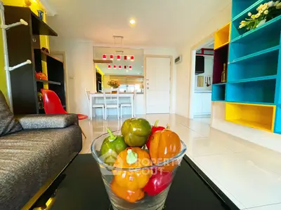 Stylish living room with colorful shelving and modern dining area