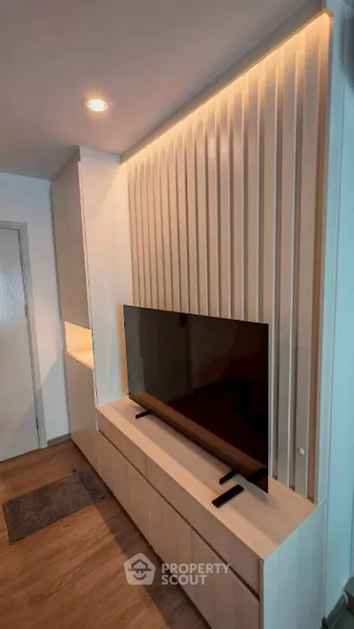 Modern living room with sleek TV unit and ambient lighting