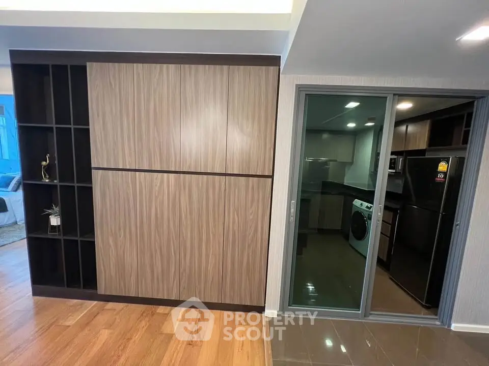 Modern apartment interior with sleek kitchen and stylish wooden cabinetry