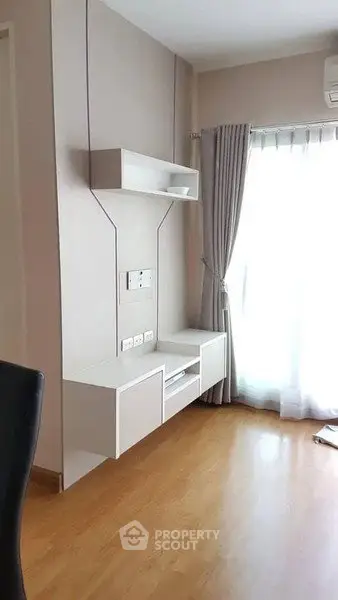 Modern living room with sleek wall-mounted storage and large window
