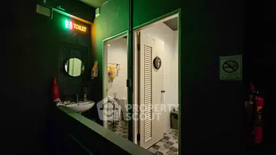 Modern bathroom with neon toilet sign and stylish decor