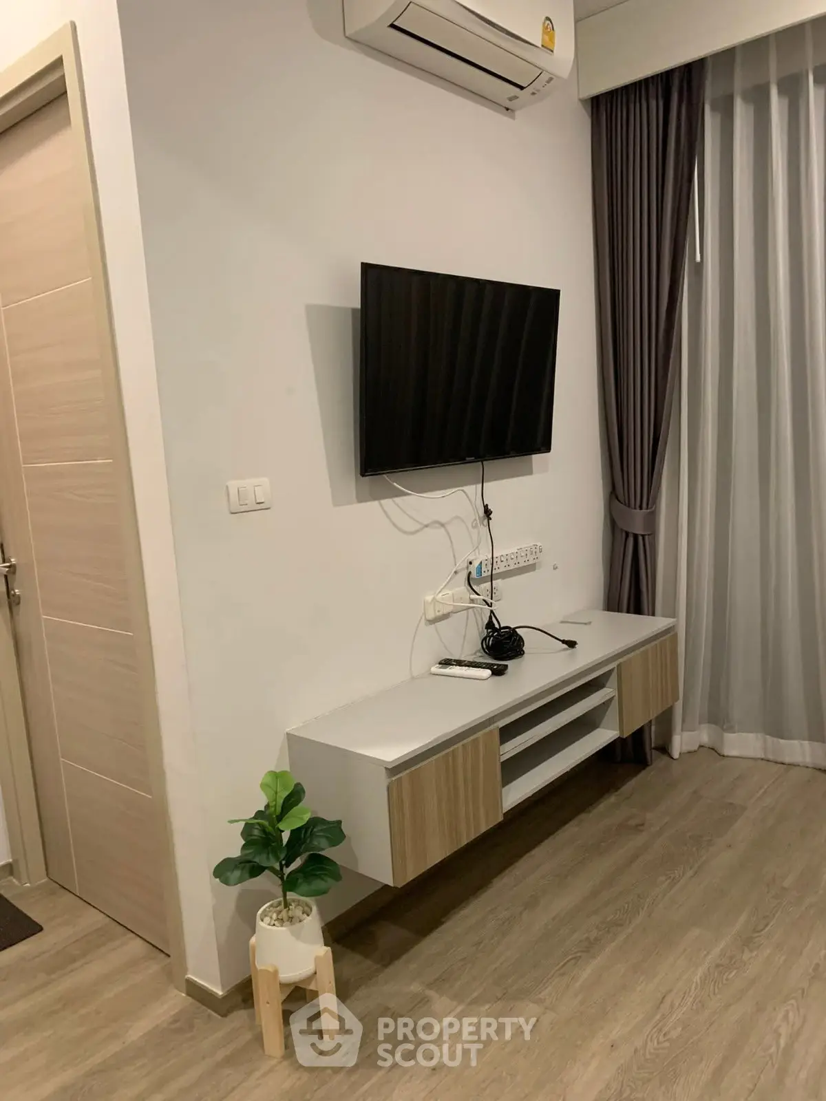 Modern living room with wall-mounted TV and stylish decor