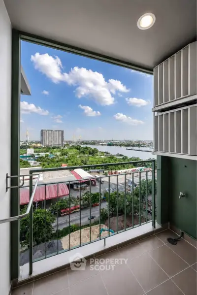 Stunning balcony view overlooking river and cityscape with clear blue skies.