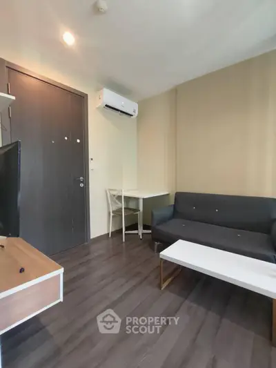 Modern living room with sleek furniture and air conditioning in a cozy apartment.