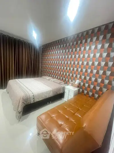 Stylish bedroom with modern geometric wallpaper and cozy furnishings