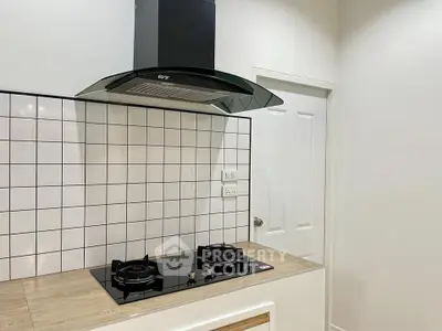 Modern kitchen with sleek gas stove and stylish backsplash