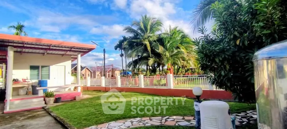 Charming tropical garden with lush greenery and cozy outdoor seating area