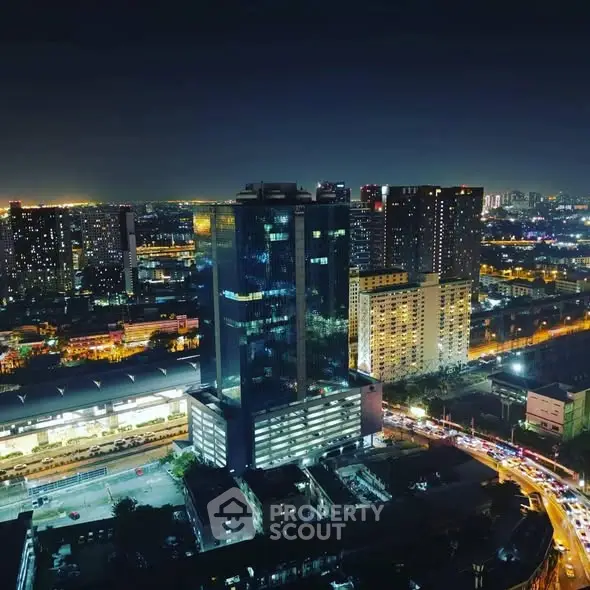 Stunning night view of city skyline with illuminated skyscrapers and bustling streets.