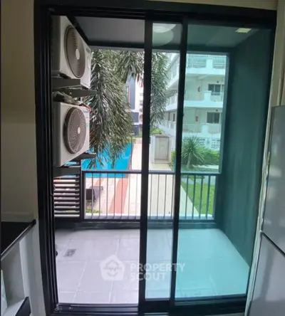 Modern balcony with pool view in a stylish apartment complex