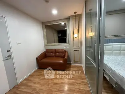 Modern bedroom with glass partition and cozy leather sofa