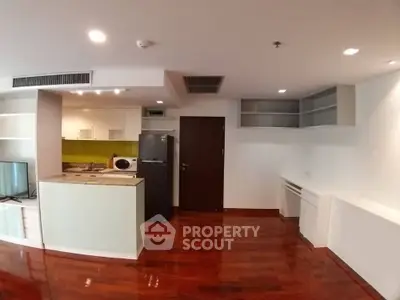 Modern open-layout kitchen with sleek appliances and hardwood flooring