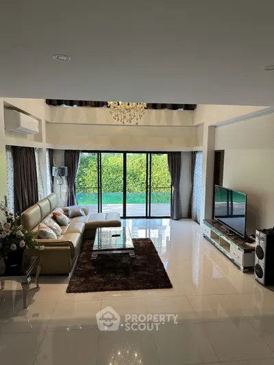 Spacious modern living room with large windows and elegant decor