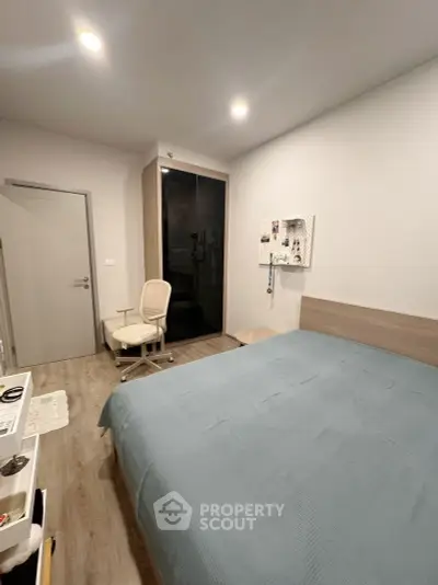 Modern bedroom with sleek wardrobe and cozy bed in minimalist design.