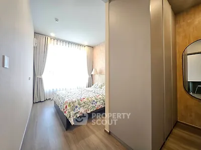 Spacious bedroom with modern decor and large window for natural light