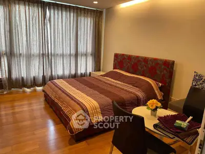 Spacious bedroom with elegant decor and natural light