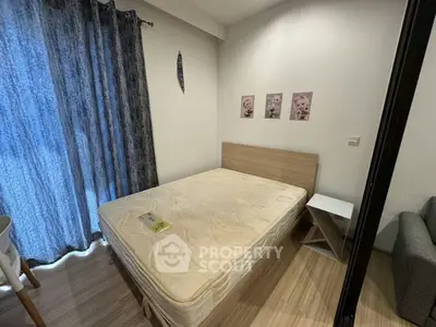 Cozy bedroom with natural light and modern decor, featuring a comfortable bed and stylish furnishings.