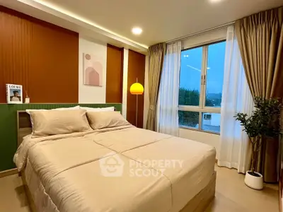 Cozy bedroom with modern decor and large window offering scenic views