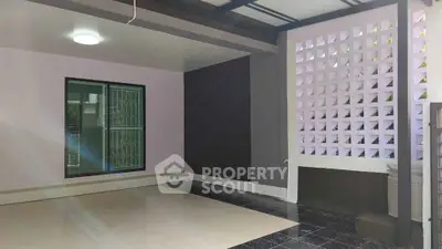 Spacious modern interior with unique wall design and ample natural light.