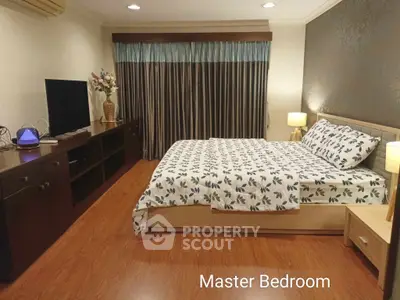 Spacious master bedroom with elegant decor and modern furnishings