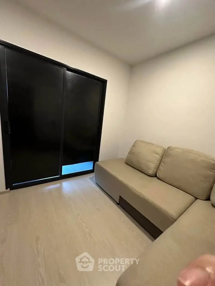 Cozy living room with modern sofa and large sliding glass door