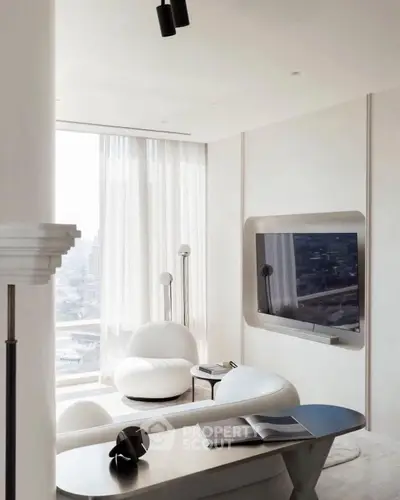 Modern living room with sleek furniture and large window view