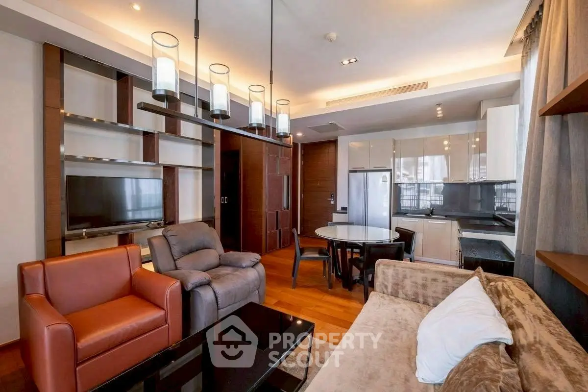 Modern living room with stylish furniture and open kitchen layout in luxury apartment.