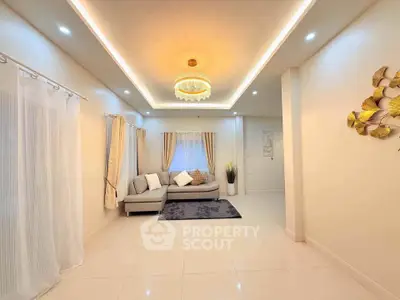 Elegant living room with modern lighting and cozy sofa in a bright, spacious interior.