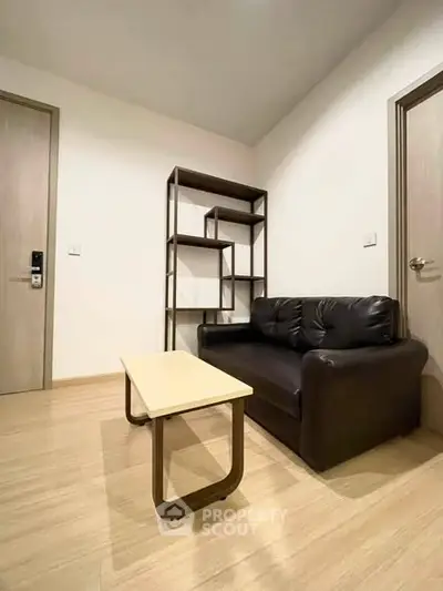 Cozy living room with modern sofa and stylish shelving unit, perfect for urban living.