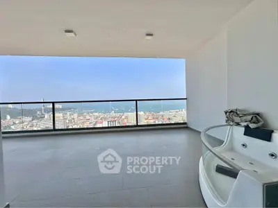 Spacious balcony with stunning city view and luxurious jacuzzi.