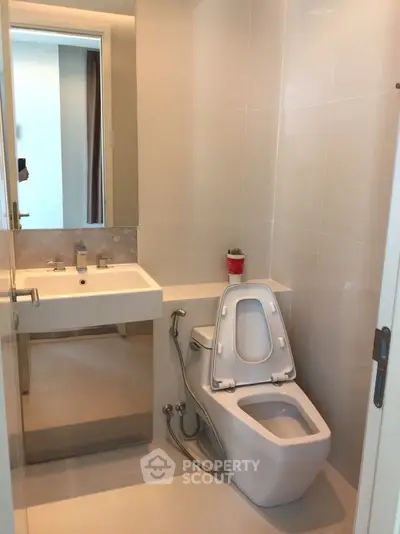 Modern bathroom with sleek fixtures and neutral tones, perfect for a contemporary home.
