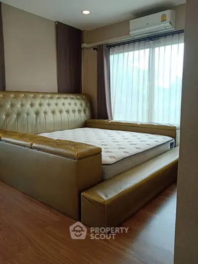 Luxurious bedroom with elegant leather bed and large window view