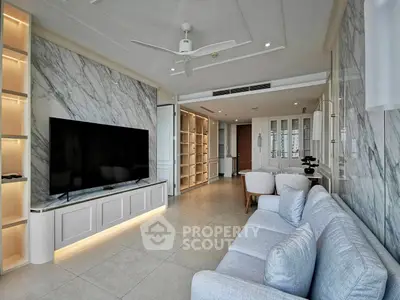 Luxurious modern living room with marble accents and spacious seating area.