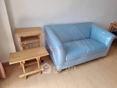 Cozy living room with blue sofa and wooden side tables